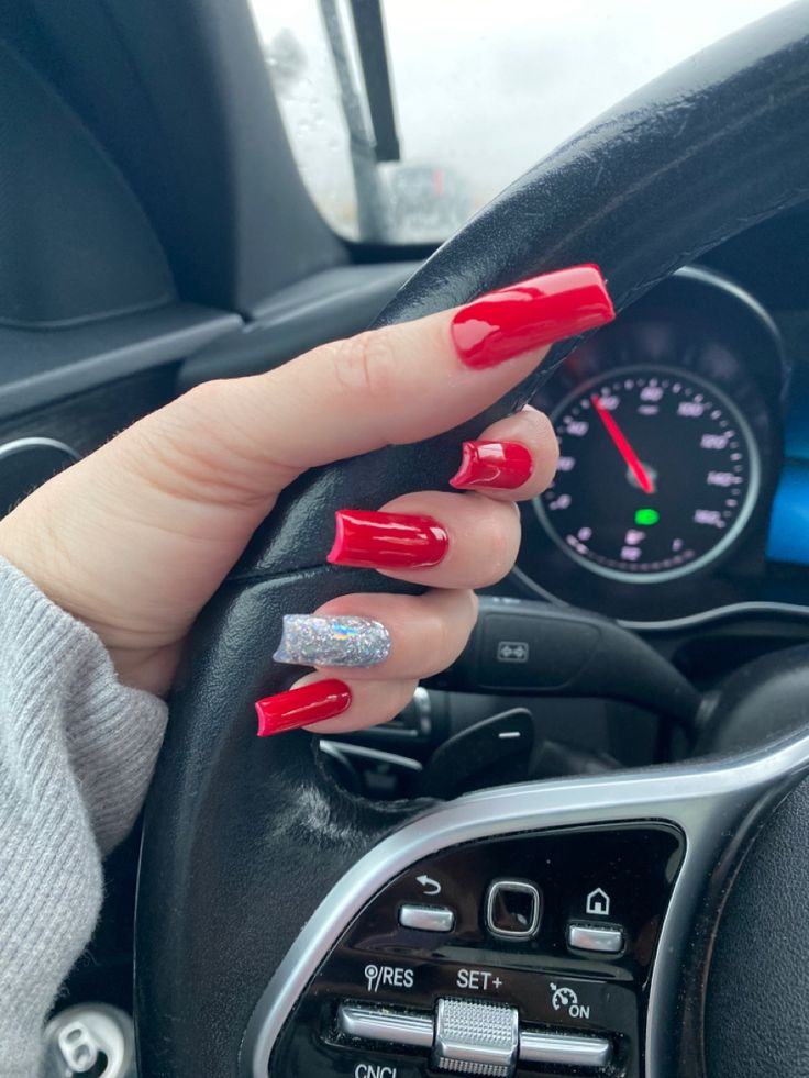 Striking Elegant Design: Vibrant Red Long Nails with Shimmering Silver Accent.