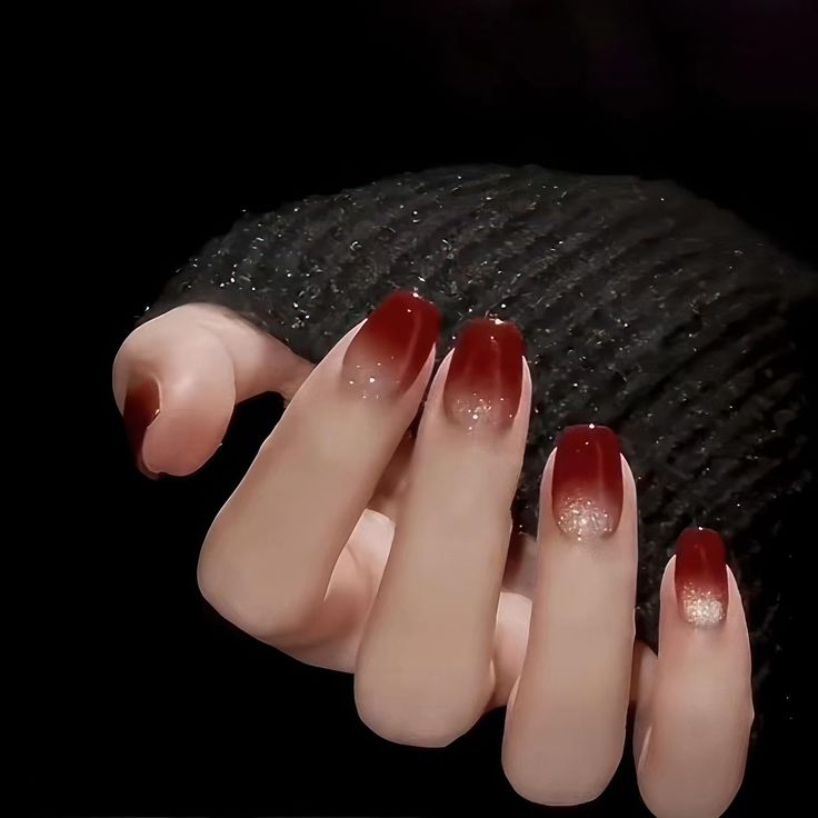 Sophisticated Deep Red Ombre Nails with Shimmer for Any Occasion.