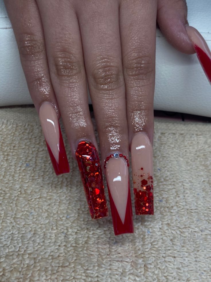 Elegant Red and Nude Nail Design with Glitter and Rhinestones