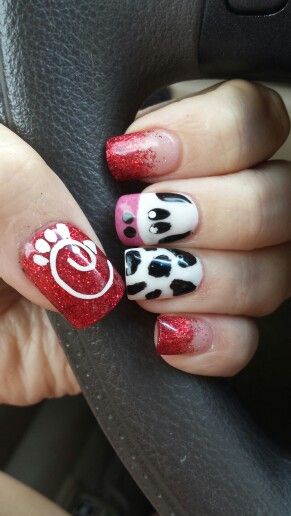 Playful Vibrant Nail Art: Red Glitter, Cow Print, and Whimsical Accents.