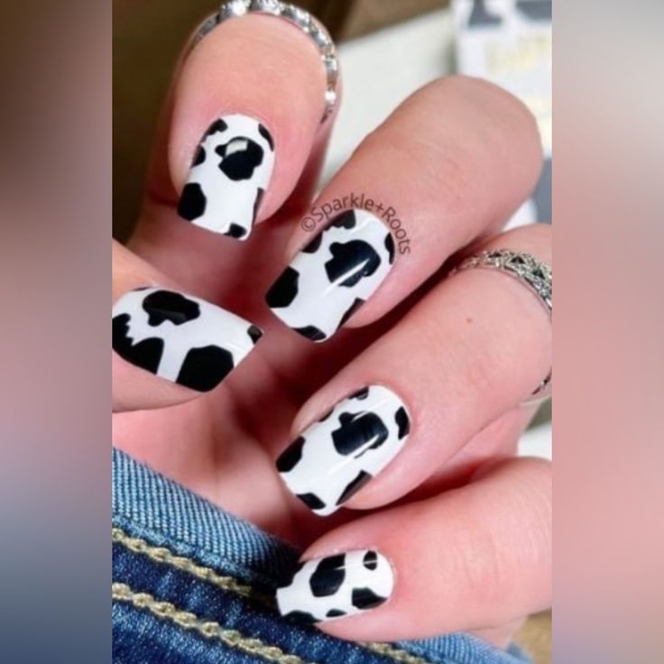 Trendy Cow Print Nail Design: Eye-Catching Black and White Spot Pattern for a Bold Statement.