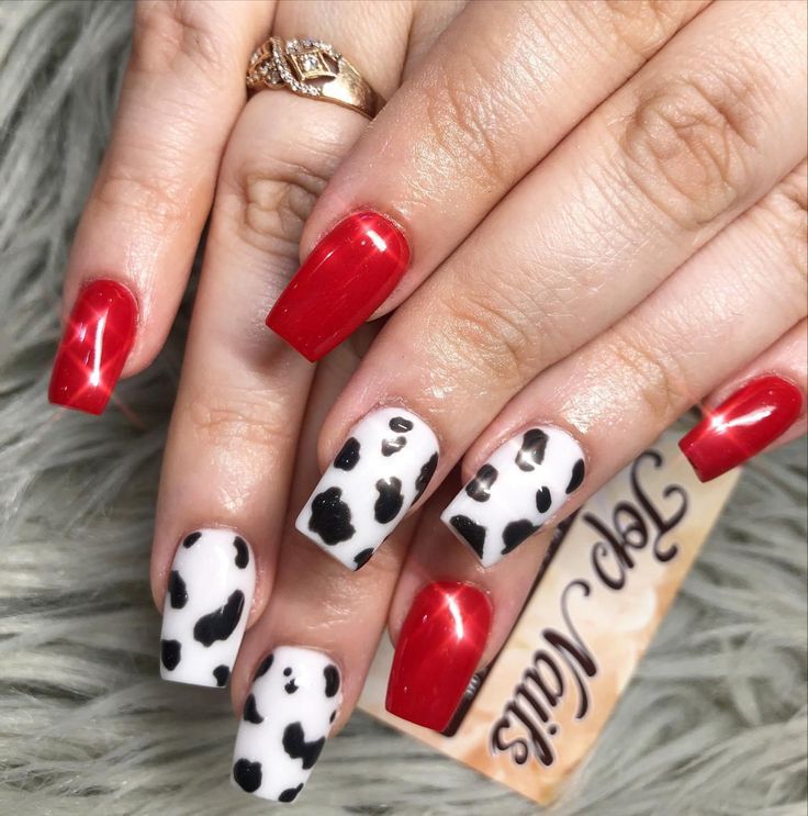 Playful Bold Red and Cow Print Nail Art: A Striking Visual Balance