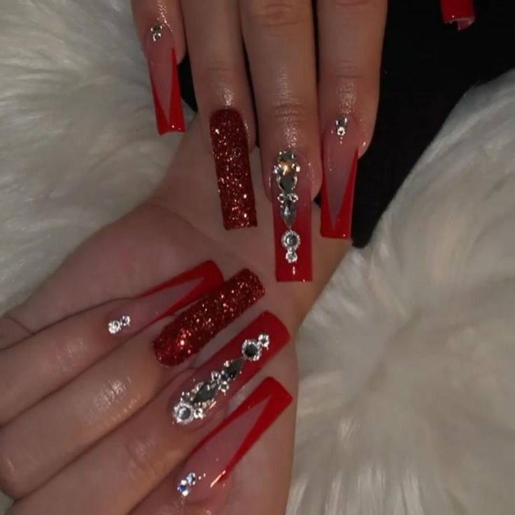 Elegant Bold Red Nail Design with Glossy and Glitter Finishes, Geometric Patterns, and Rhinestone Accents.