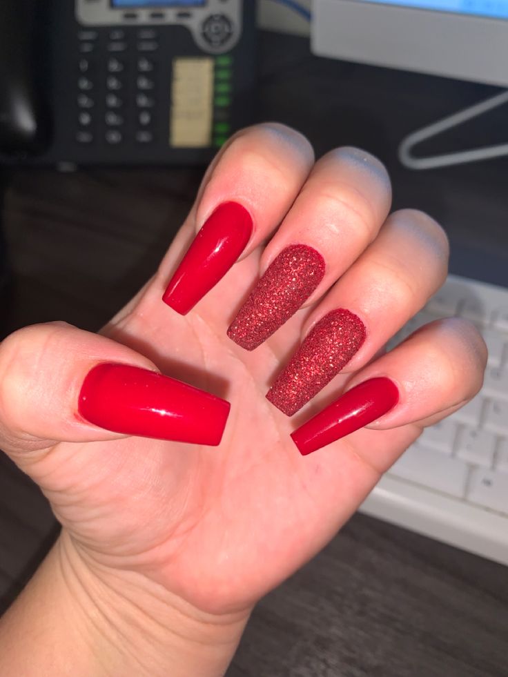 Bold Red Nail Design with Glossy Textures and Glitter Accents for a Statement Look.