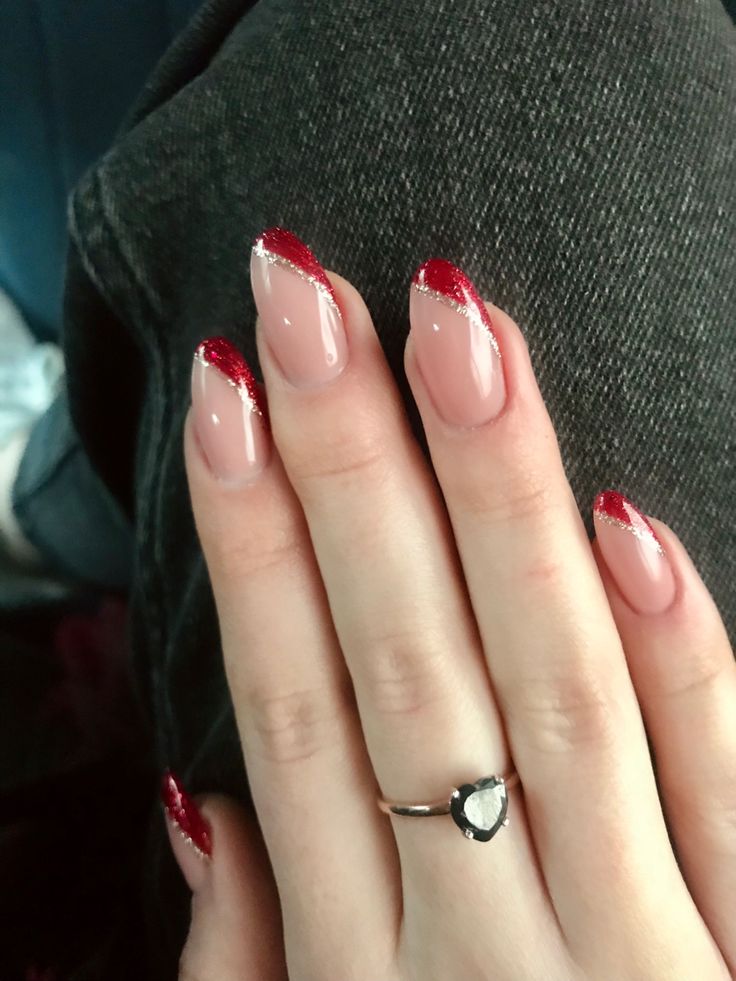 Sophisticated French Manicure with Red Tips and Glitter Accents.