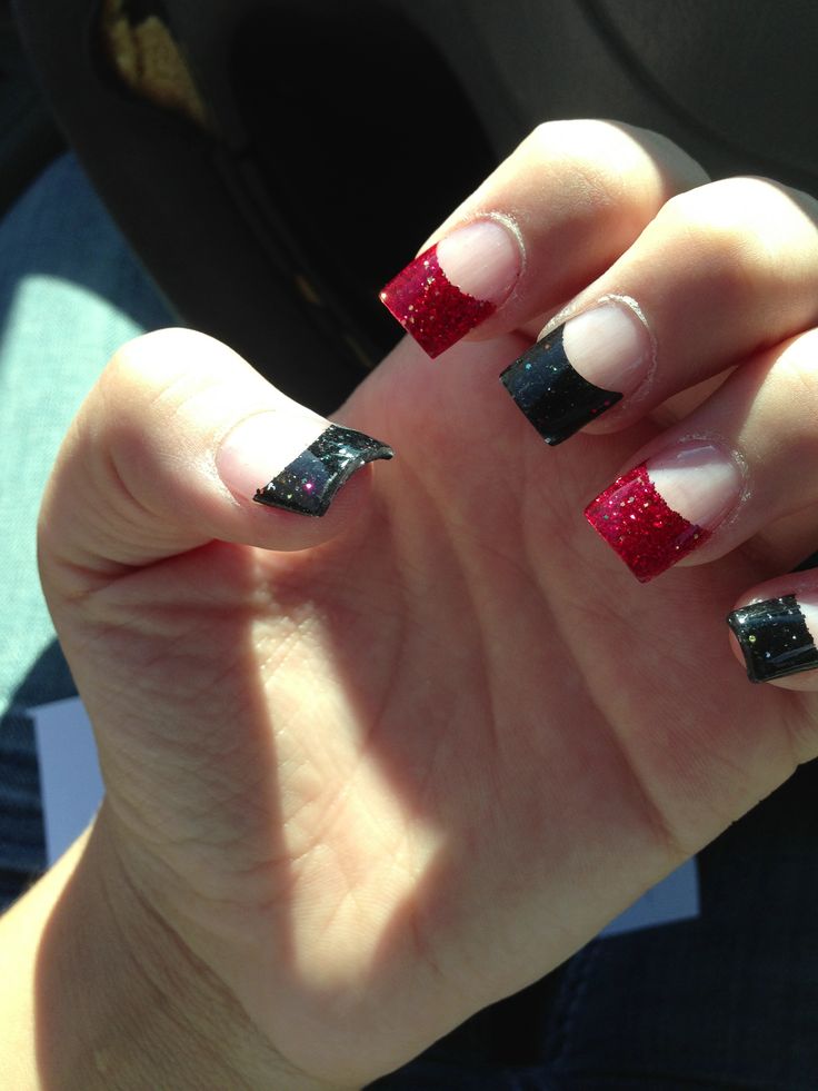 Bold Black and Glittery Red French Tip Nail Design for a Glamorous Statement.