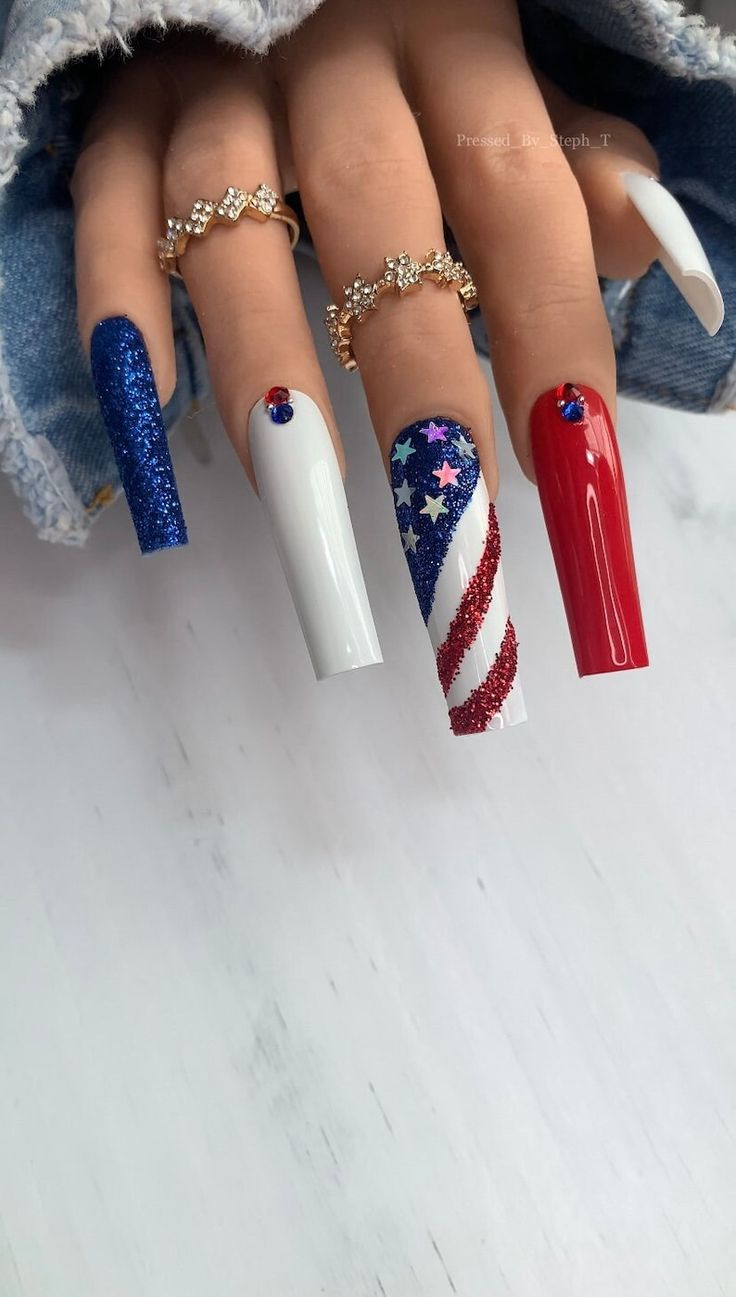 Festive Patriotic Nail Art: Vibrant Stripes and Stars in Blue, Red, and White.