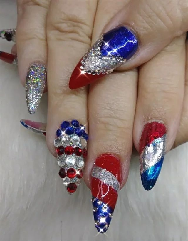 Bold Stiletto Nail Design with Vibrant Colors and Intricate Patterns for Celebrations.