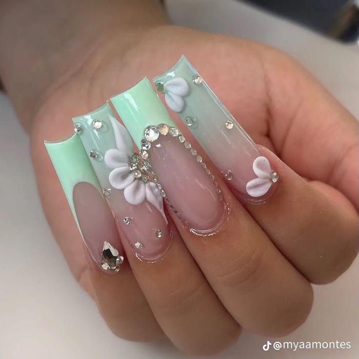 Playful Elegance: Whimsical Mint Green Nail Design with Floral Accents and Rhinestones