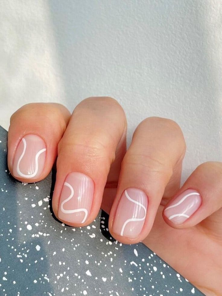 Elegant Pink Nail Design with Delicate White Swirls for a Modern Minimalist Look.