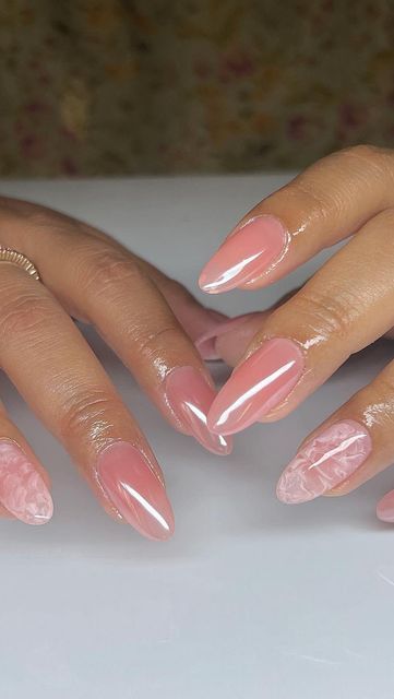 Elegant Soft Pink Nail Design with Sophisticated Marble Patterns and Glossy Finish