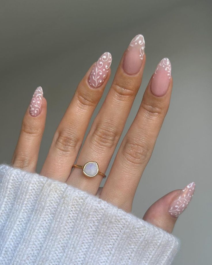 Sophisticated Almond-Shaped Nails with Delicate Floral Design and Minimalist Accent.