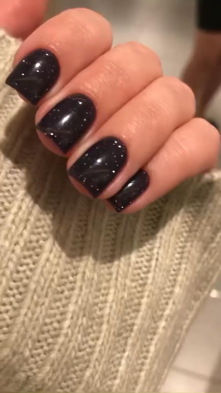 Chic Elegant Dark Nails with Glossy Finish and Glitter Accents for a Sophisticated Look.