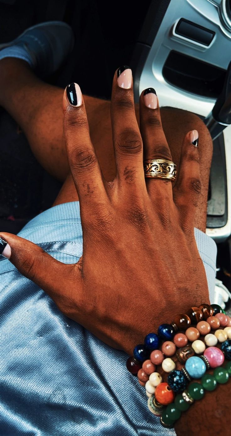 Chic Nail Design Blending Neutral and Bold Shades with Vibrant Beaded Accessories.