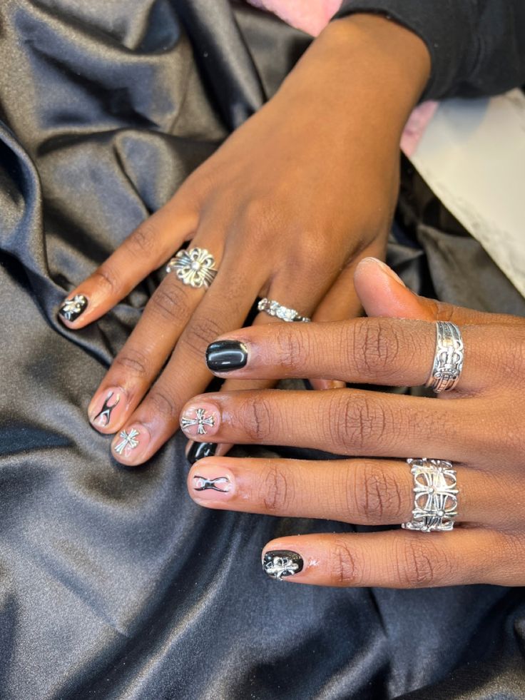 Sophisticated Black and Nude Nail Design with Intricate Art and Silver Accents.