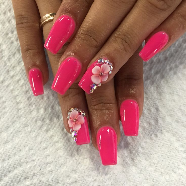 Chic Pink Nail Design with Glossy Finish and Glamorous Floral Accents.