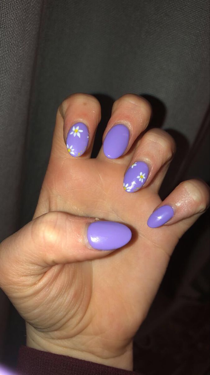 Cheerful Vibrant Purple Nail Design with Floral Accents and Textured Finishes.