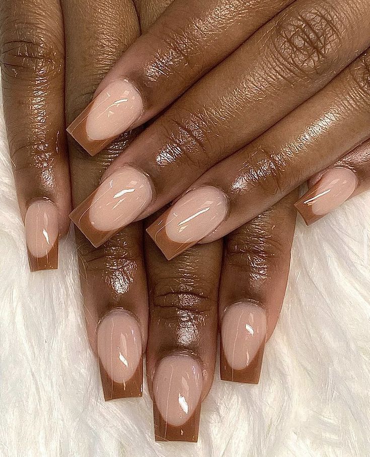 Sophisticated Ombre Nail Design with Nude Base and Glossy Brown Tips.