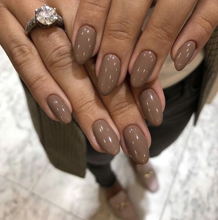 Sophisticated Almond-Shaped Taupe Nails: A Chic and Elegant Accessory for Any Occasion.