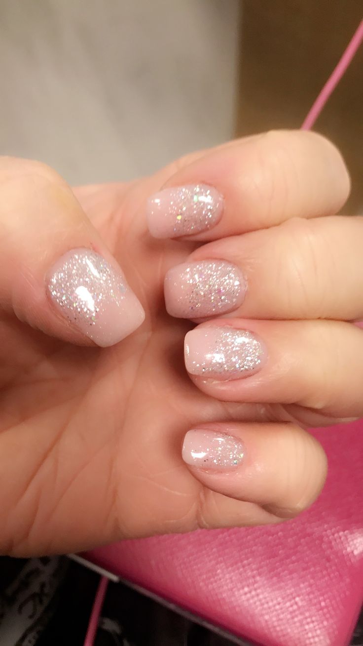 Elegant Soft Pink Nail Design with Shimmering Silver Glitter Accents.