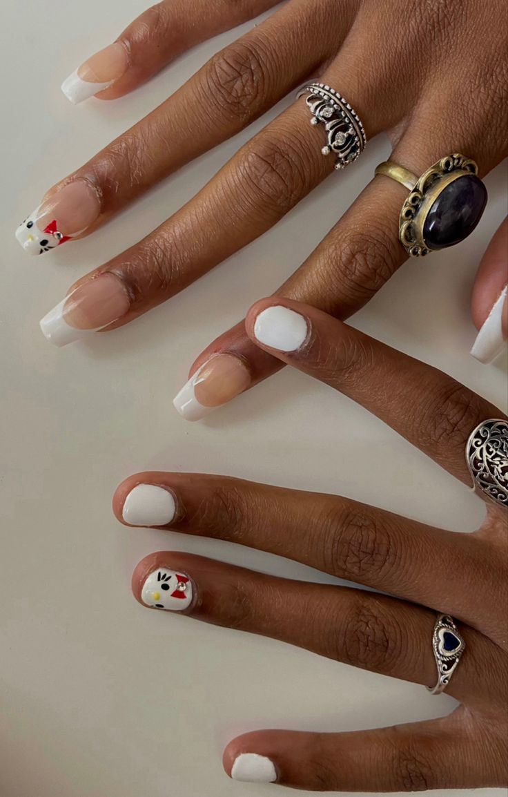 Sophisticated French Tip Nail Designs with Artistic Accents for a Playful Twist