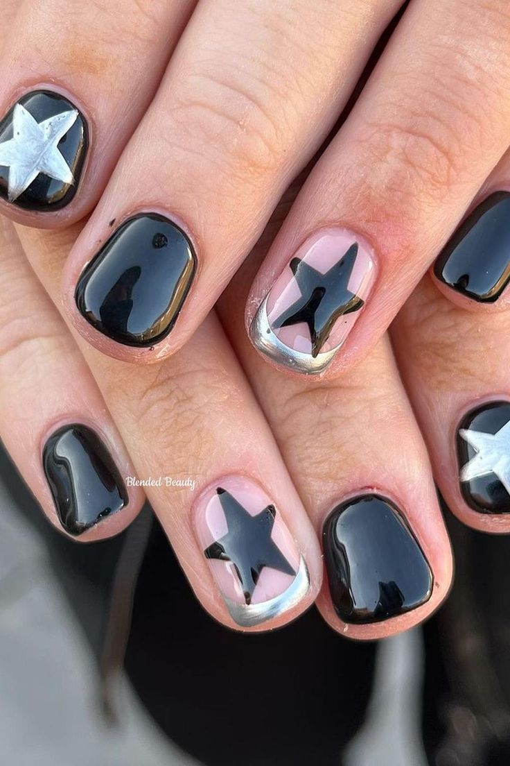 Chic Black and Silver Nail Design with Star Motifs and Modern Negative Space