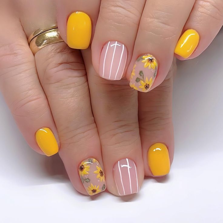 Cheerful Spring/Summer Nail Design with Floral Patterns and Sleek Stripes.