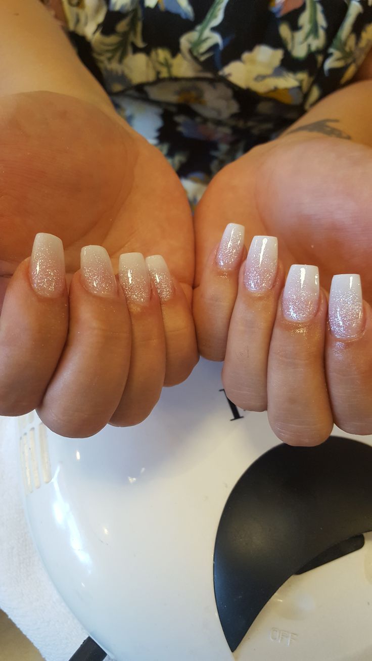 Elegant Glittery Ombre Nails with Soft Pink and White Gradient for Glamorous Occasions.