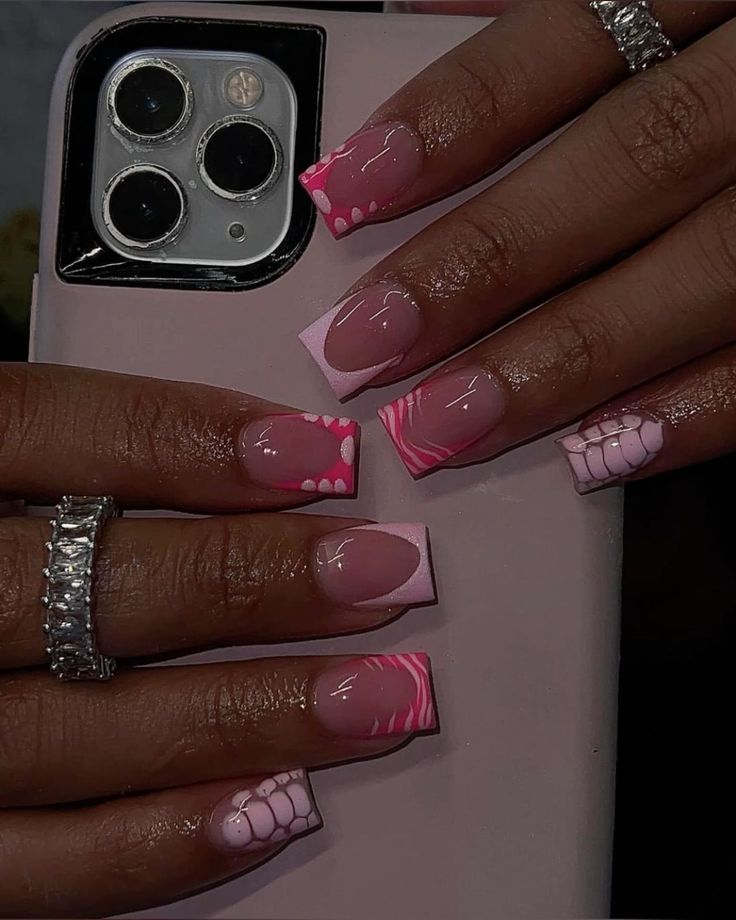 Chic Nail Design: Soft Pink Shades Meet Vibrant Patterns and Textured Finishes.