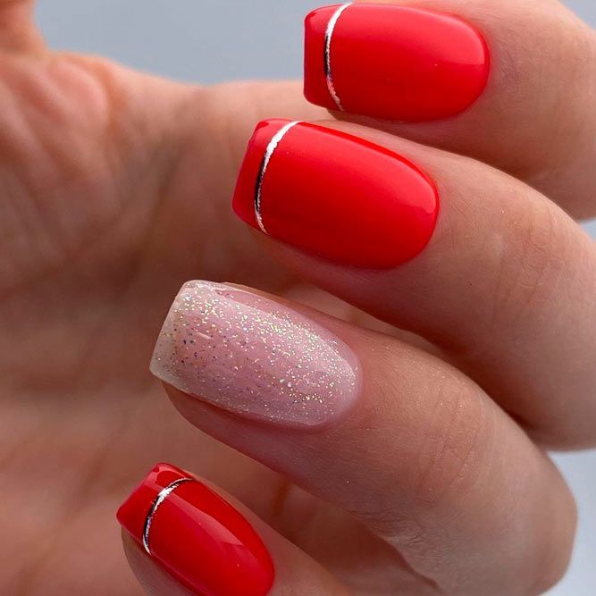 Striking Vibrant Red Manicure with Sparkly Accents and Elegant Silver Stripes.