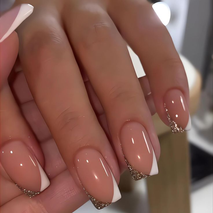 Chic Nude Nails with White Tips and Glam Gold Accents for a Modern Look.