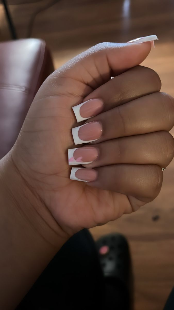 Timeless French Tip Nail Design with Soft Nude Base and Feminine Pink Accents.