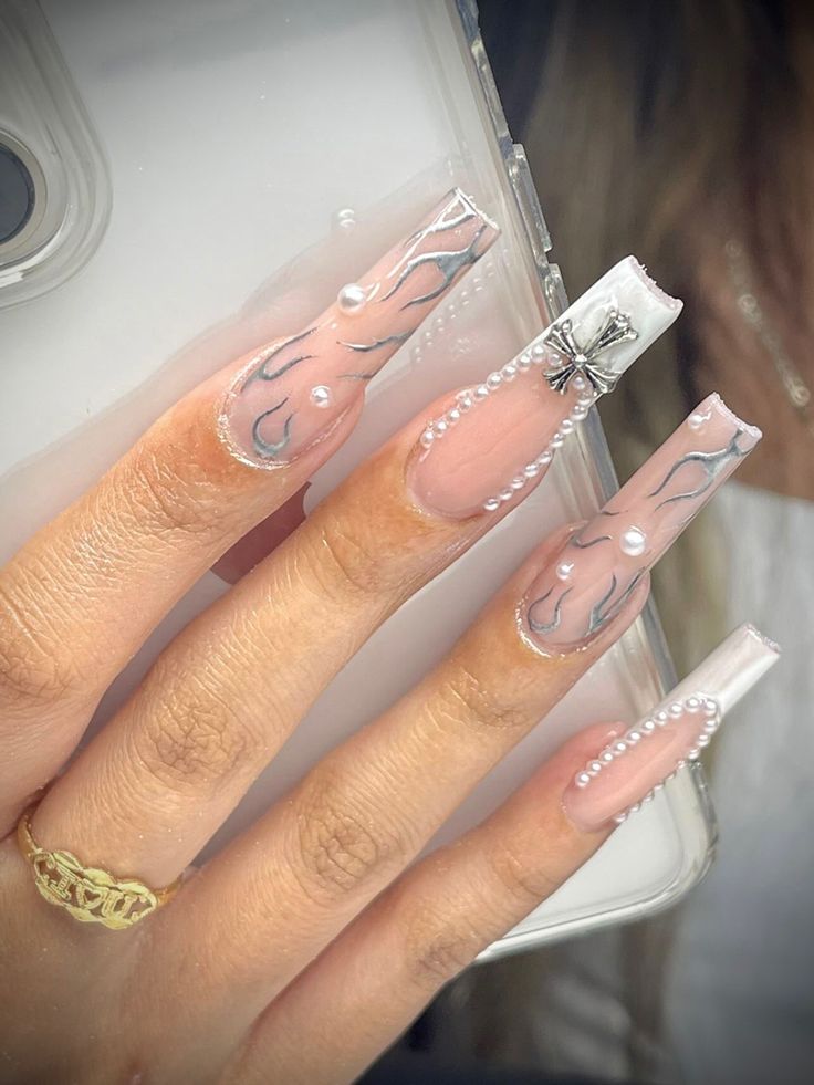 Sophisticated Elegant Nail Design with Elongated Tips and Intricate Flame Patterns.