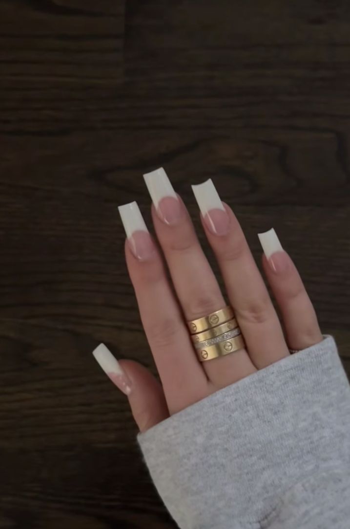 Sophisticated French Manicure with Blush Base and Gold Ring Accents