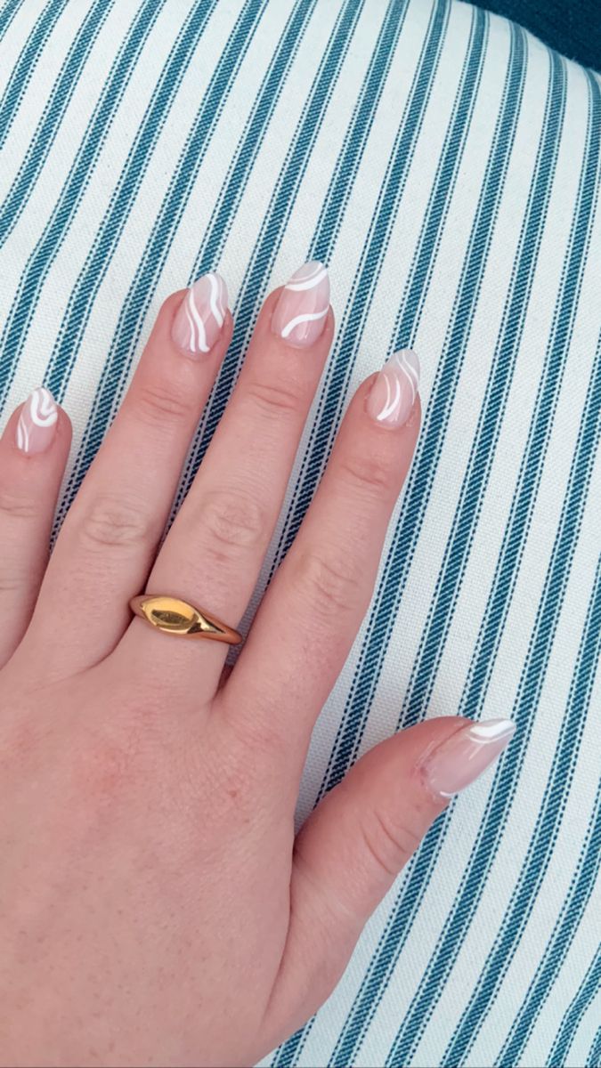 Chic Nude and White Swirled Nail Design Enhanced by a Stylish Gold Ring.