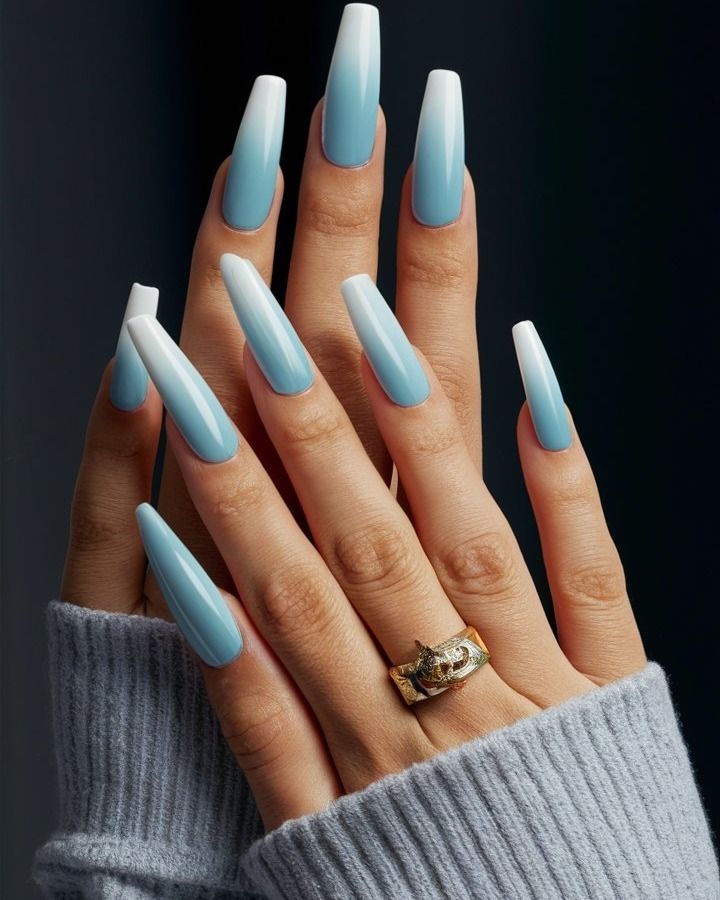 Elegant Soft Blue and White Gradient Elongated Nails Complemented by Delicate Jewelry and Cozy Sweater.