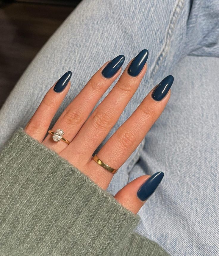 Chic Deep Navy Almond-Shaped Nails: A Sophisticated Look with Gold and Silver Accents.