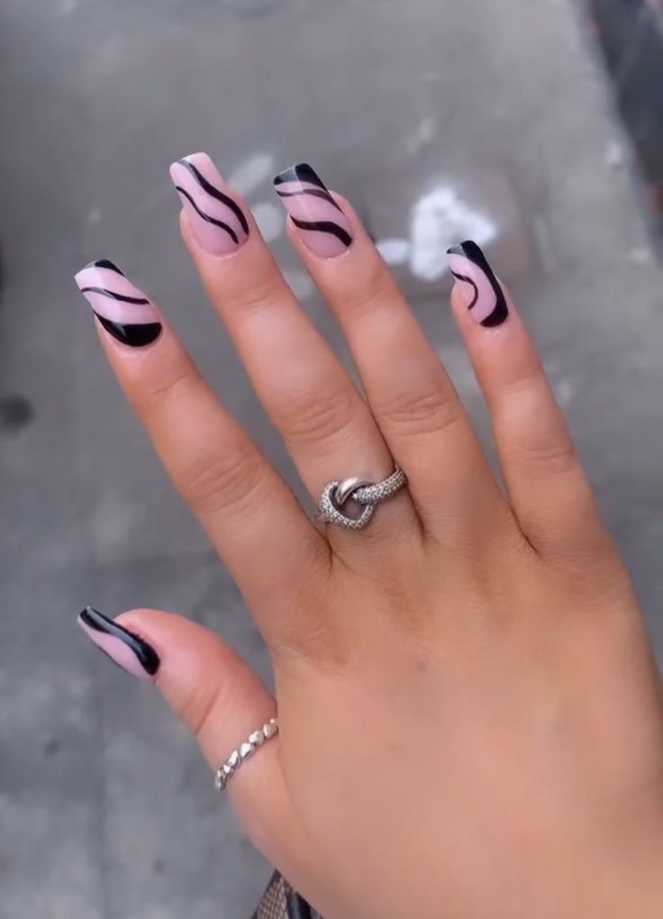 Chic Soft Pink and Bold Black Swirl Nail Design for Sophistication.