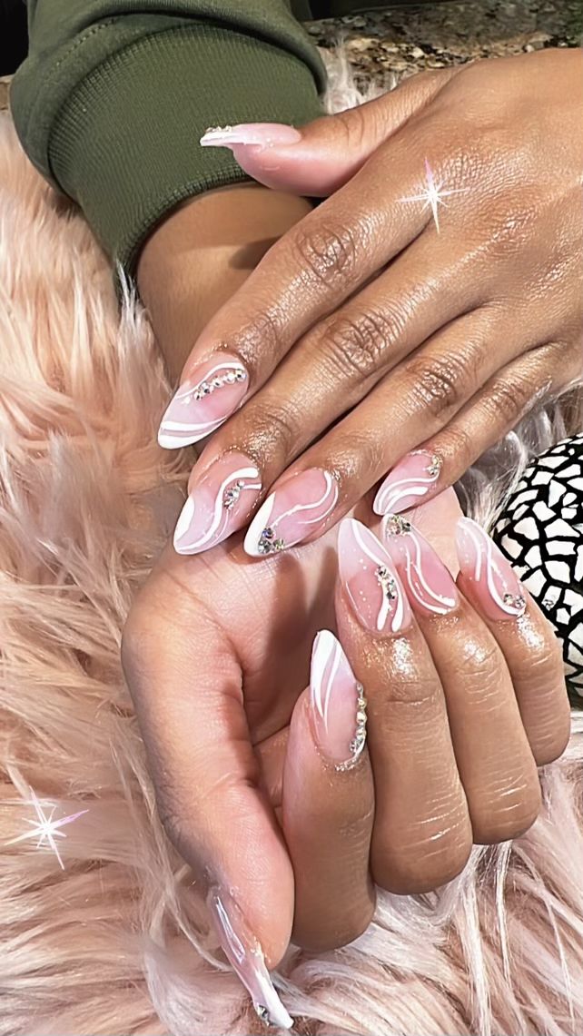 Chic Almond-Shaped Nail Design with Soft Pink, White, and Glamorous Rhinestones