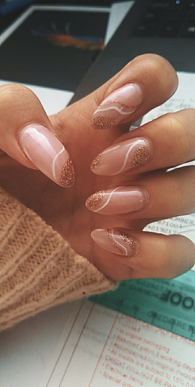 Sophisticated Almond-Shaped Nails with Soft Nude Base and Shimmering Rose Gold Accents.