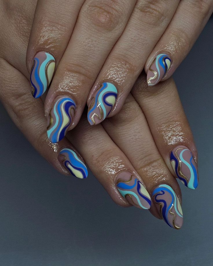 Vibrant Swirling Nail Art: A Creative Blend of Pastels and Bold Blues.