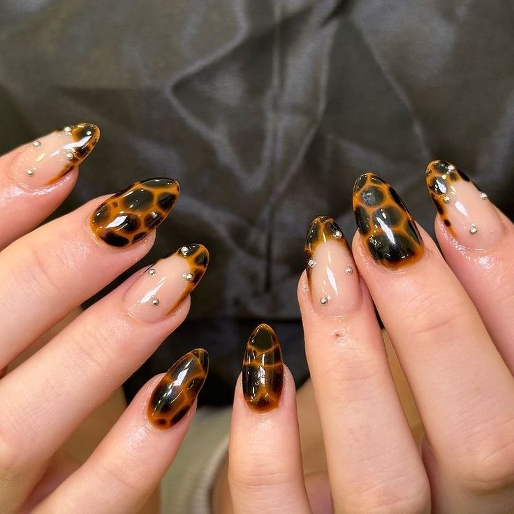 Stunning Tortoiseshell Nail Design with Glossy Finish and Glam Silver Accents.