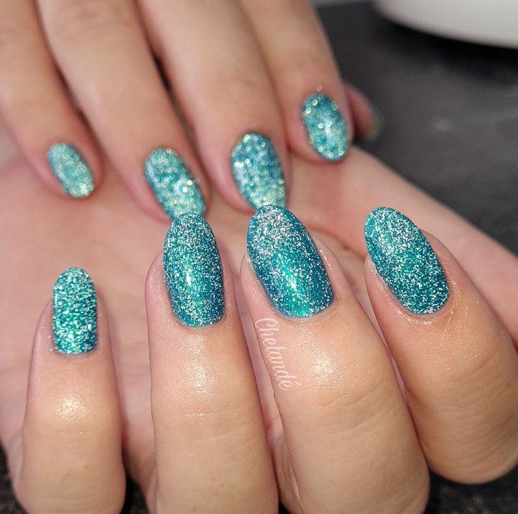 Glamorous Sparkling Teal Nail Design with Textured Glitter for Special Occasions.