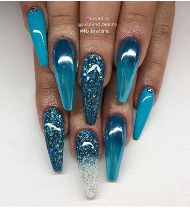 Elegant Turquoise Nail Design with Glossy Finishes, Glitter Gradient, and Glamorous Accent Stones.