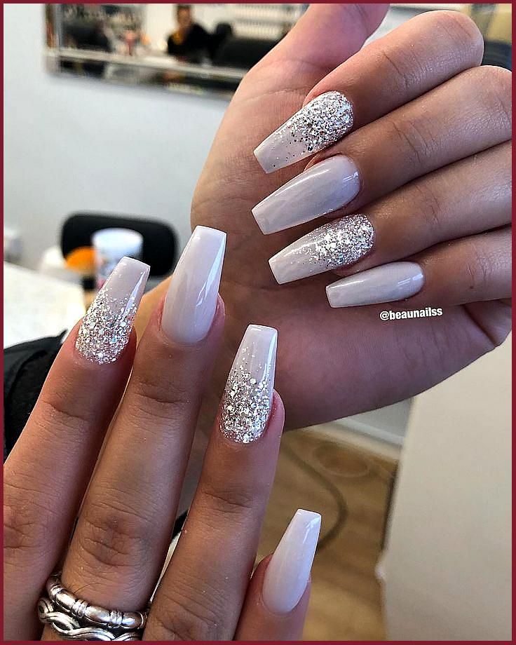 Sophisticated Long Square Nail Design with Creamy White Base and Glitter Accents.