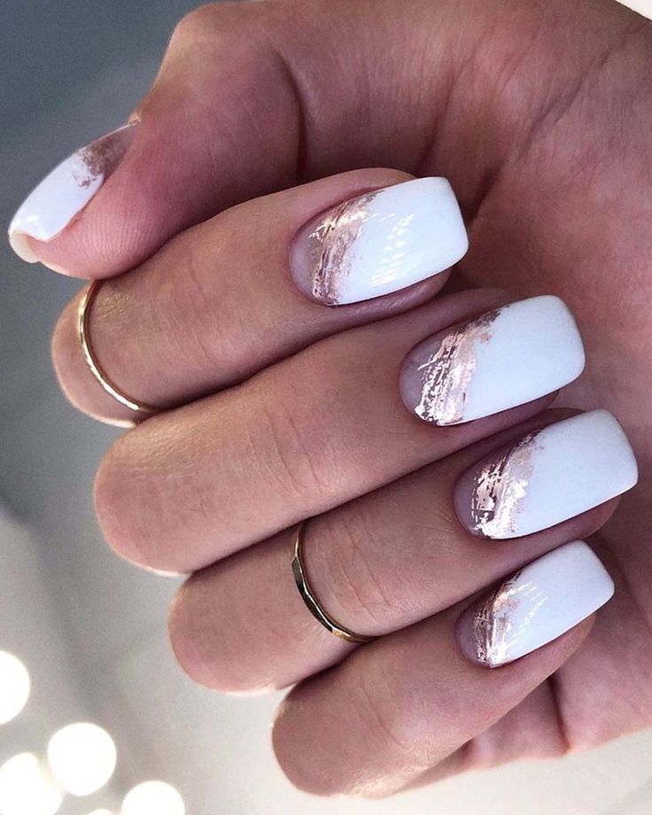 Elegant Chic Nail Design: Glossy White Base with Rose Gold Accents and Gradient Effect.