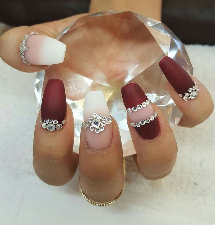 Sophisticated Nail Design: Deep Burgundy and White with Glossy-Matte Mix and Rhinestone Accents.