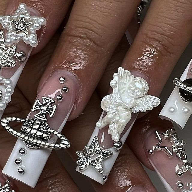 Luxurious Ornate Nail Design with Playful Textures and Whimsical Silver Embellishments.