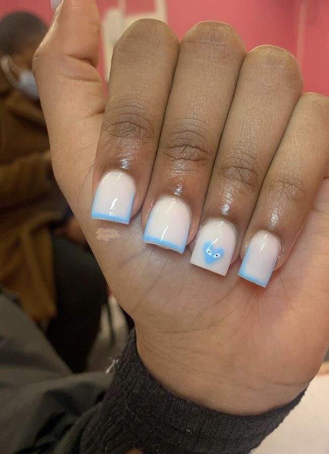 Chic Modern French Tip Nail Design with Soft Blue Gradient and Playful Detail.