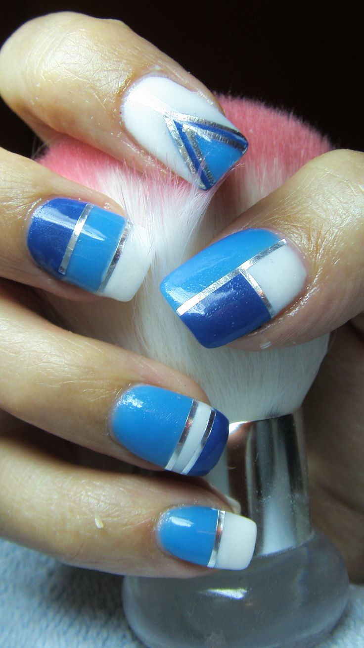 Chic Blue and White Geometric Nail Design with Metallic Accents.